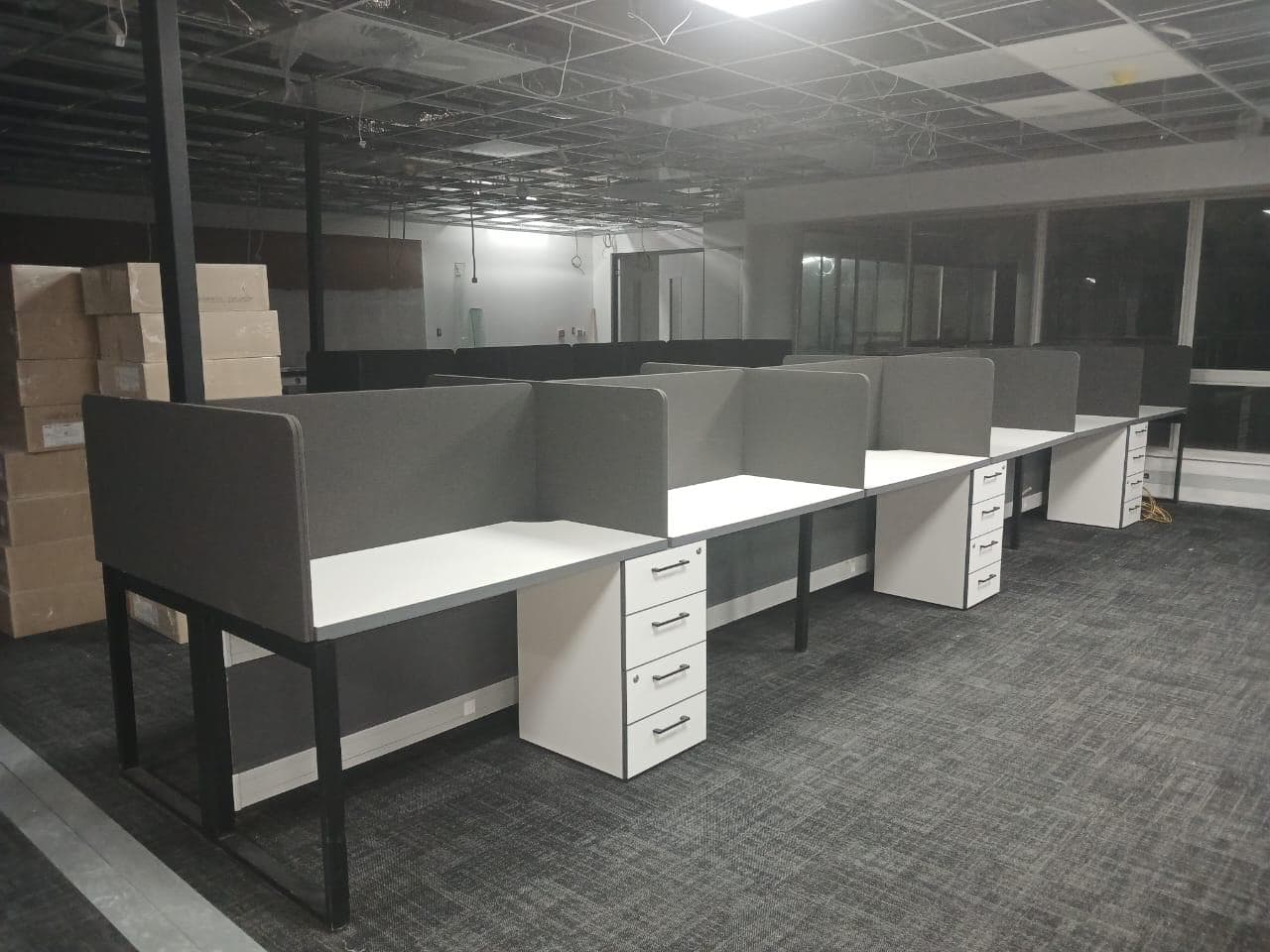 Completed office workstations beneath electrical services at Amazon Building
